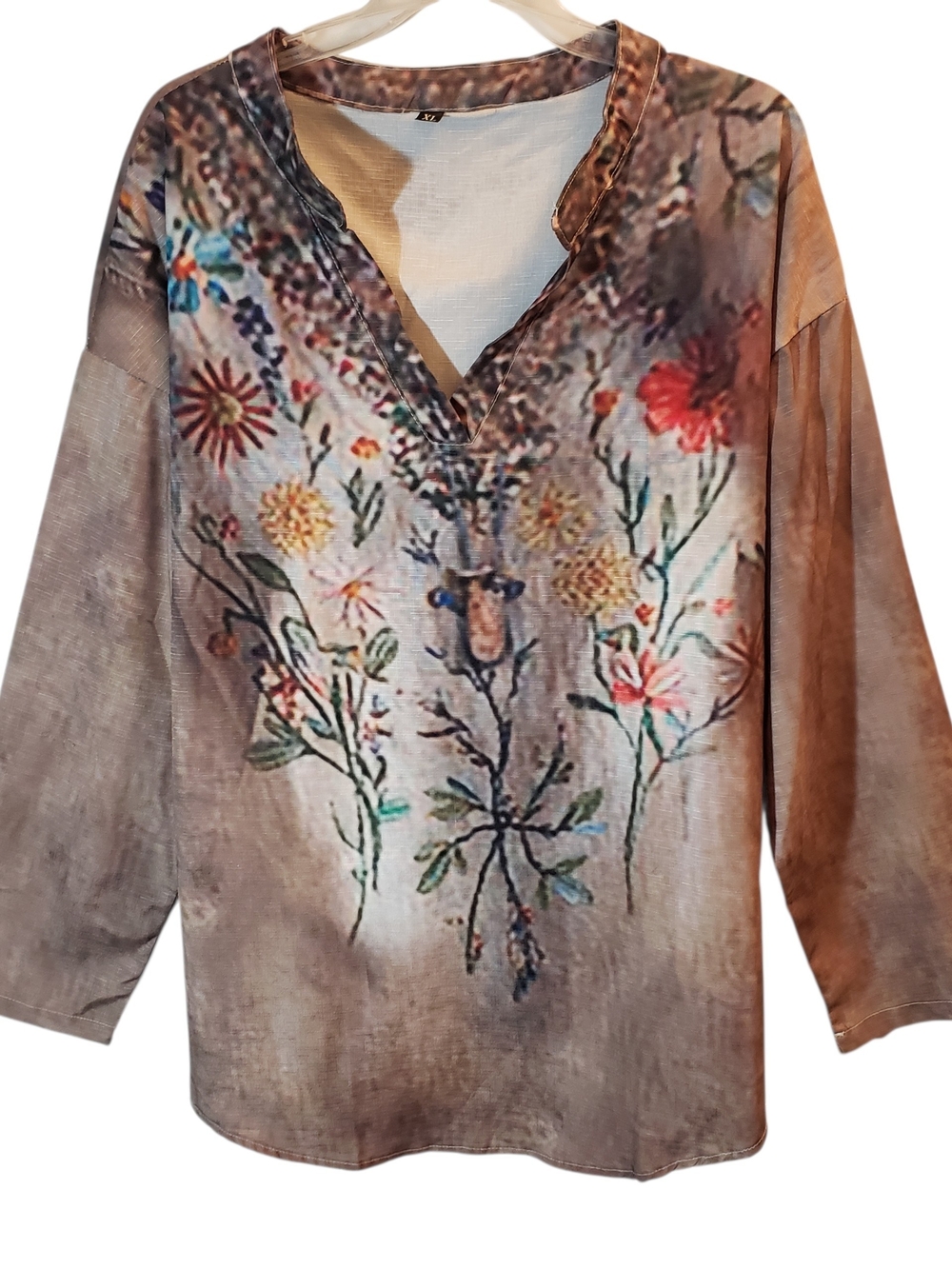 Bohemian-style Xl printed tunic blouse characterized by its split v-neckline.